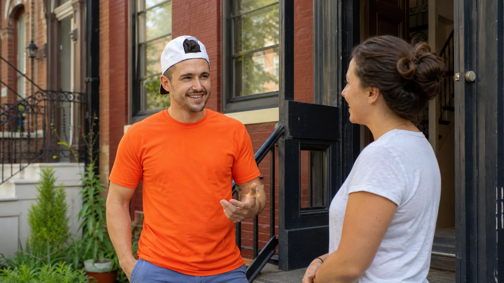Ben speaking with a neighbor at their DC rowhouse doorstep